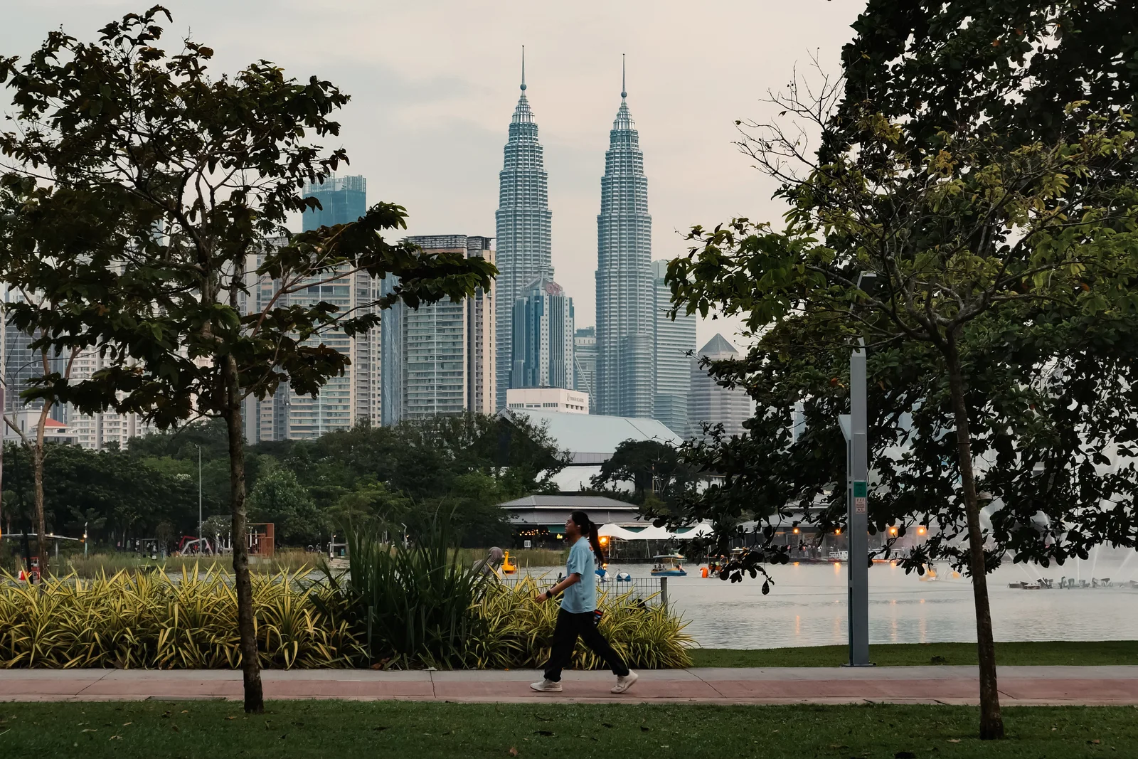 A park path with the Petronas Towers in the distance