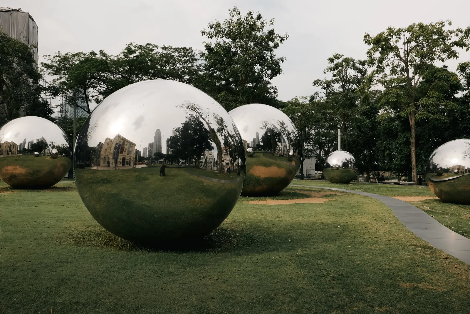 Silver sphere sculptures on a lawn