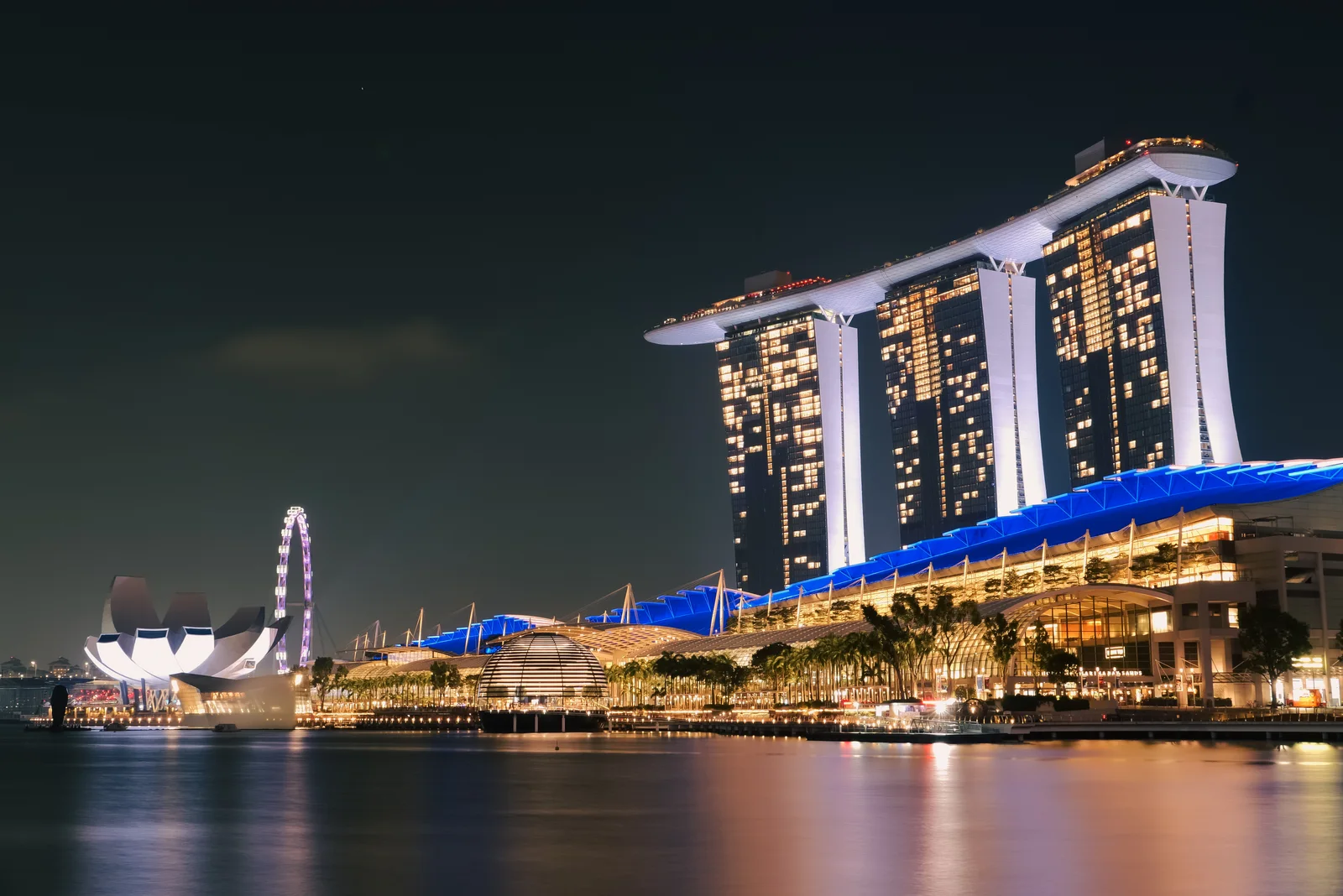 Marina Bay Sands and the Ferris wheel lit up at night