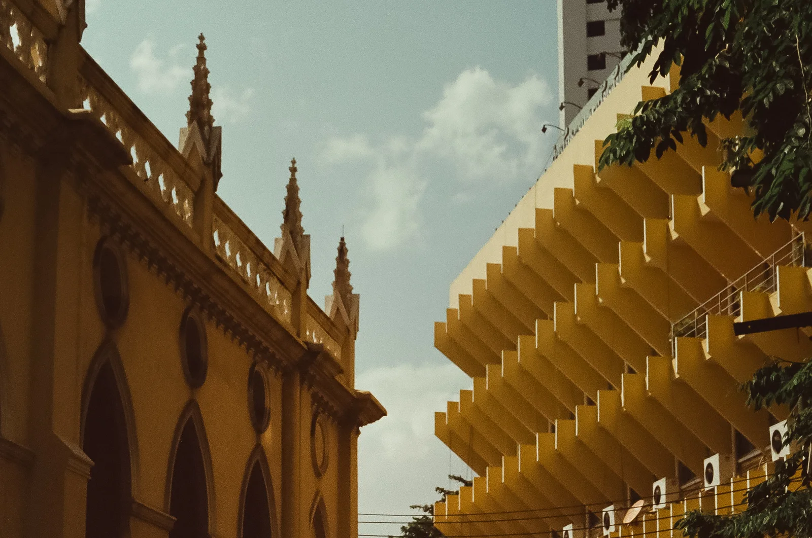 A colonial building facade against a blue sky, shot on film