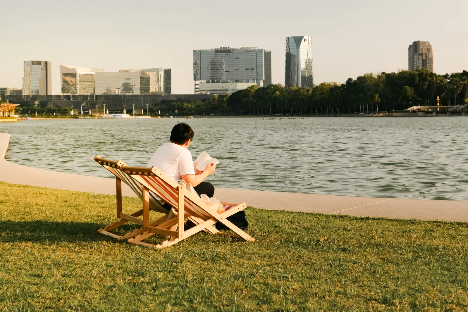 A deck chair by the lake with the skyline behind
